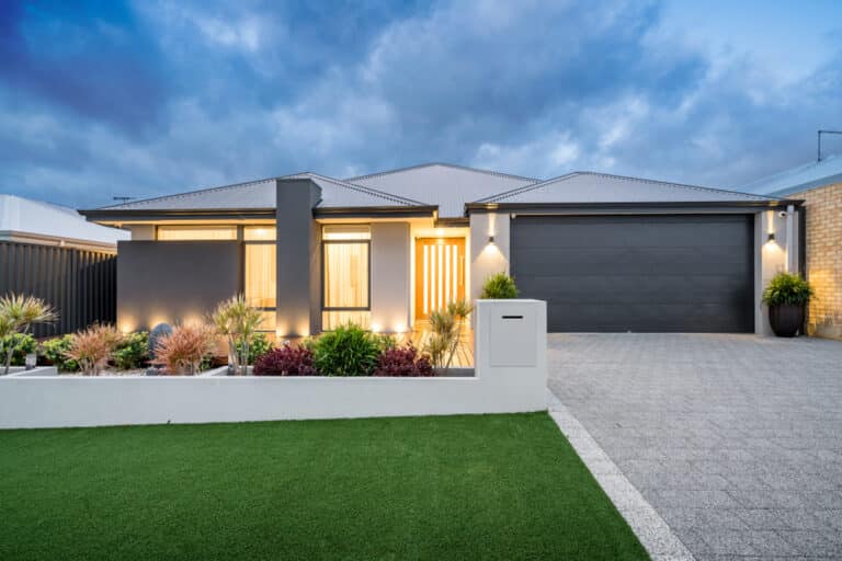 A contemporary home featuring a well-maintained driveway and landscaped garden.