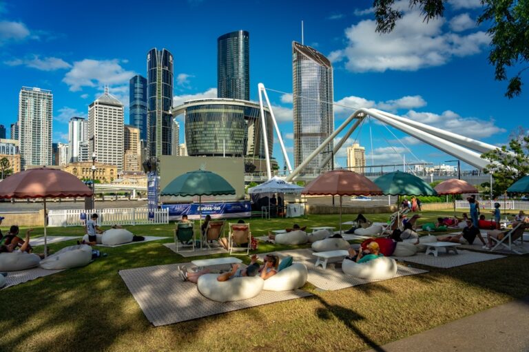 People relaxing at Summer Hub in South Bank with Queen's Wharf Tower Star Casino in the background